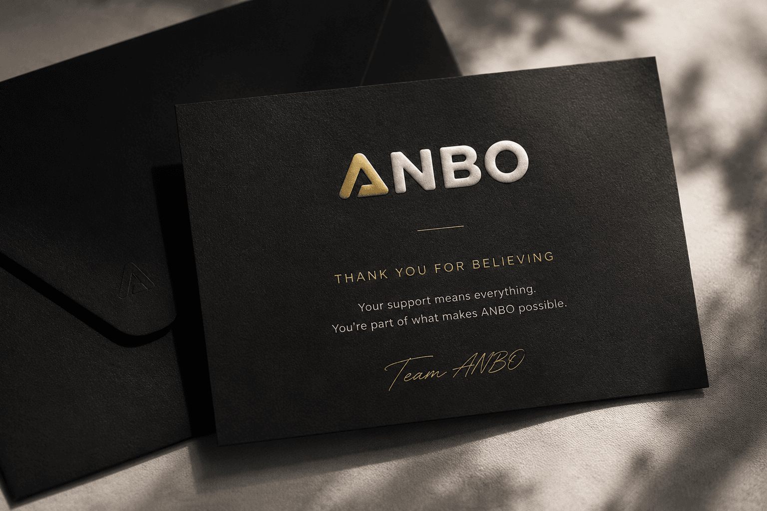 ANBO thank you card on a premium black envelope — Thank you for believing
